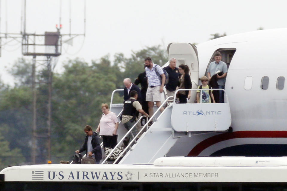 People exit a plane from Ireland that made an emergency landing because of an unspecified threat, Wednesday, Aug. 7, 2013, in Philadelphia. (AP Photo/Matt Rourke)