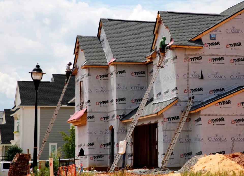 In this file photo, a construction crew work on a new home in the Arden Mill subdivision in Fort Mill. New census data show change in home values and other housing details across the Rock Hill region.
