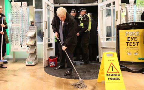 Prime Minister Boris Johnson helps with the clean up at an opticians as he visits Matlock on November 8, 2019 in Sheffield, England. - Credit: Getty Images Europe