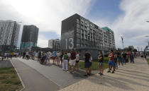 People queue to cast their votes in the Belarusian presidential election in Minsk, Belarus, Sunday, Aug. 9, 2020. Belarusians are voting on whether to grant incumbent president Alexander Lukashenko a sixth term in office, extending his 26-years rule, following a campaign marked by unusually strong demonstrations by opposition supporters. (AP Photo/Sergei Grits)