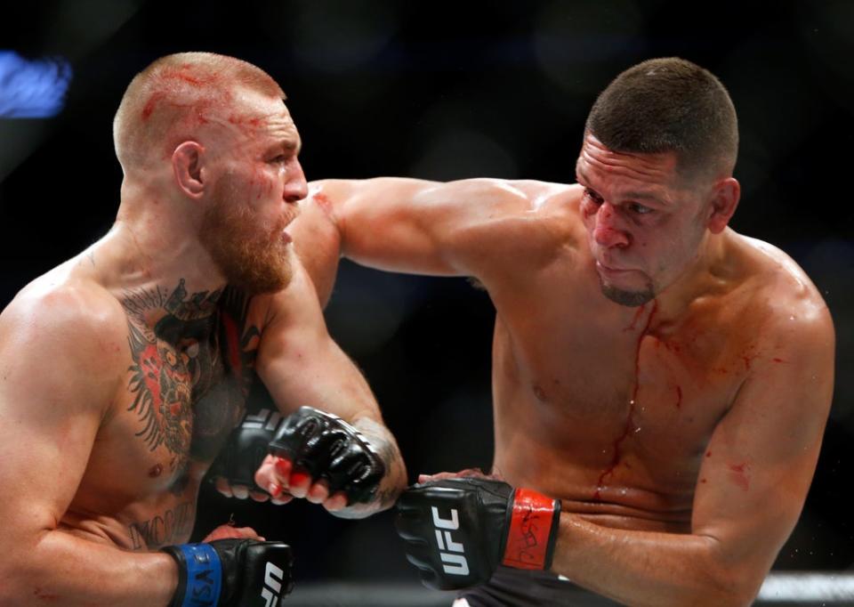 Conor McGregor and Nate Diaz battle during their welterweight rematch at the UFC 202 in 2016 (Getty)