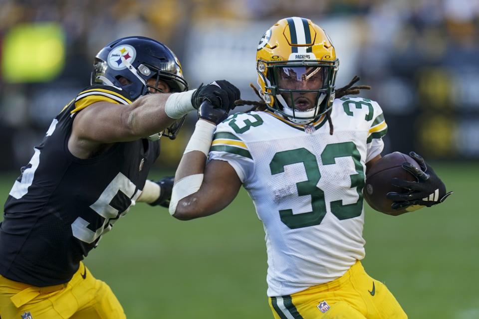 Pittsburgh Steelers' Cole Holcomb tries to stop Green Bay Packers' Aaron Jones during the second half of an NFL football game Sunday, Nov. 12, 2023, in Pittsburgh. (AP Photo/Matt Freed)