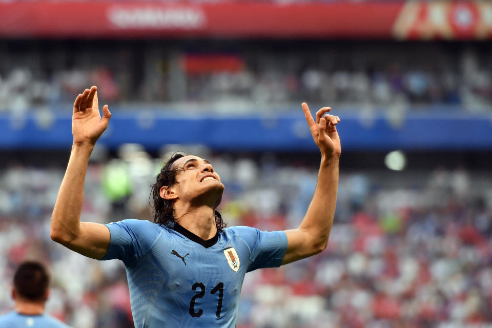 <p>Edinson Cavani points to the sky after getting off the mark </p>