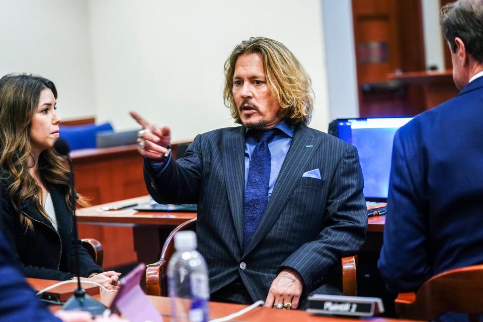 Johnny Depp expressively addresses his lawyers in court on 14 April (AP)