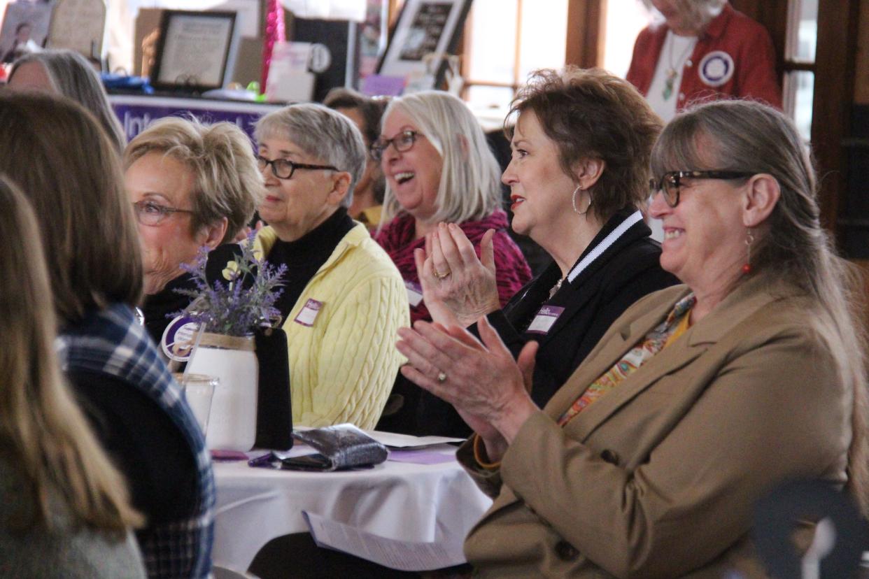 Audience members react to one of the speakers during the International Women's Day event on Saturday, March 4, 2023, at La Poste in Perry.