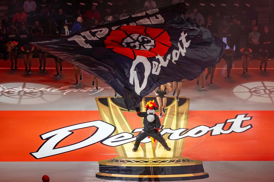 Hooper, the Detroit Pistons mascot, waves a flag on the brand new NBA In-Season Tournament court before the game against the Philadelphia 76ers at Little Caesars Arena on Friday, Nov. 10, 2023.