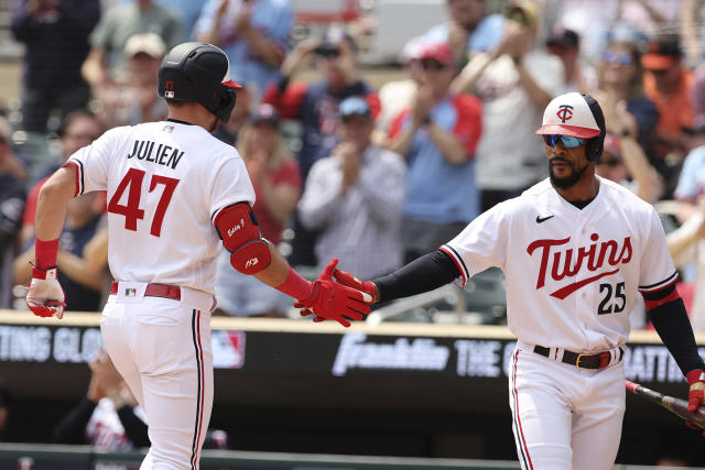 Minnesota Twins' Edouard Julien (47) high-fives Byron Buxton (25) after hitting a home run in the first inning of a baseball game against the San Francisco Giants, Wednesday, May 24, 2023, in Minneapolis. (AP Photo/Stacy Bengs)