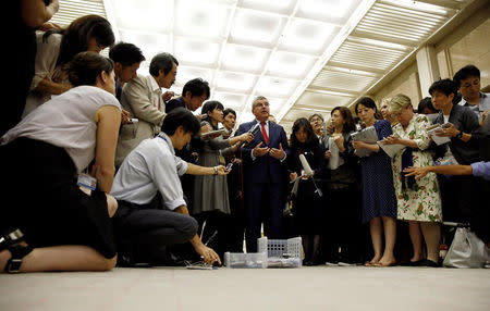 President of the International Olympic Committee Thomas Bach (C) talks to reporters after meeting Tokyo governor Yuriko Koike at Tokyo Metropolitan Government Building in Tokyo, Japan, October 18, 2016. REUTERS/Kim Kyung-Hoon