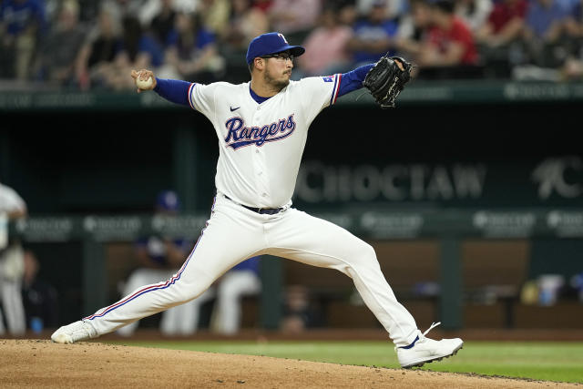 Texas Rangers manager Bruce Bochy, second from right, takes the ball from Texas  Rangers starting pitcher Martin Perez, second from left, in the top of the  sixth inning in a baseball game