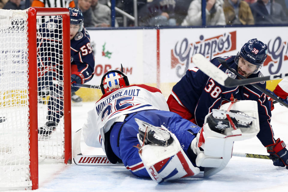 Columbus Blue Jackets forward Boone Jenner, right, watches as teammate forward Yegor Chinakhov scores past Montreal Canadiens goalie Sam Montembeault during the second period of an NHL hockey game in Columbus, Ohio, Wednesday, Nov. 29, 2023. (AP Photo/Paul Vernon)