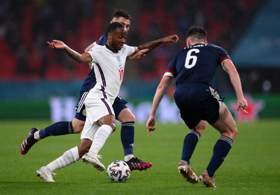 Raheem Sterling runs with the ball whilst under pressure from Kieran Tierney (Getty)