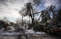 Toronto Hydro workers work to restore power following an ice storm in Toronto, December 27, 2013. Over 30,000 residents were left without power in Toronto Friday since the storm hit on December 22, local media reported. REUTERS/Mark Blinch (CANADA - Tags: ENVIRONMENT ENERGY TPX IMAGES OF THE DAY)