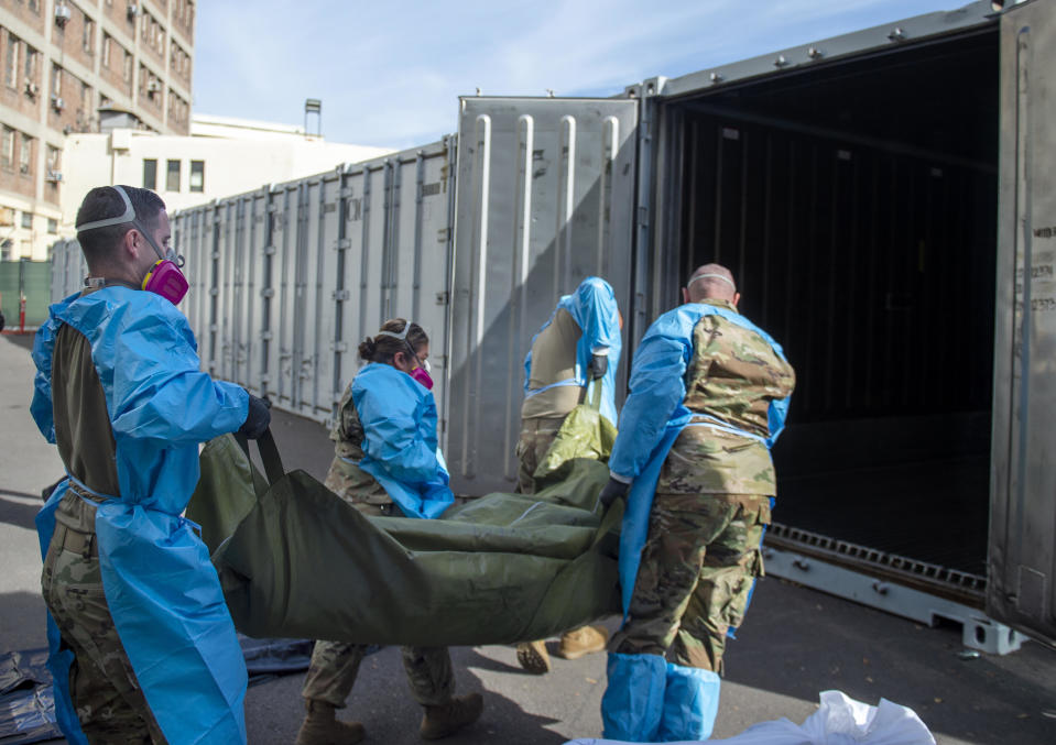 This January 12, 2021, file photo provided by the LA County Department of Medical Examiner-Coroner shows National Guard members assisting with processing COVID-19 deaths and placing them into temporary storage at the LA County Medical Examiner-Coroner Office in Los Angeles.  / Credit: AP