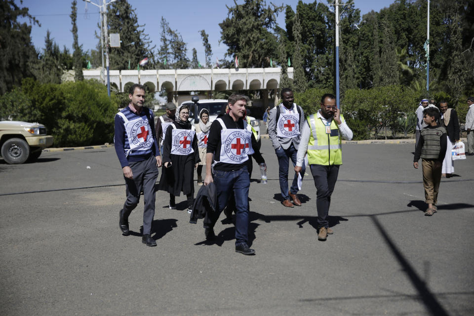 Members of the International Committee of the Red Cross (ICRC) arrive at Sanaa Airport to receive Houthi prisoners after being released by the Saudi-led coalition, Yemen, Thursday, Nov. 28, 2019. The International Committee of the Red Cross says over a hundred rebel prisoners released by the Saudi-led coalition have returned to Houthi-controlled territory in Yemen, a step toward a long-anticipated prisoner swap between the warring parties. (AP Photo/Hani Mohammed)