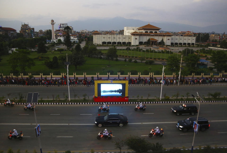 The motorcade of Chinese President Xi Jinping drives past the Nepalese parliament in Kathmandu, Nepal, Saturday, Oct 12, 2019. Xi has become the first Chinese president in more than two decades to visit Nepal, where he's expected to sign agreements on major infrastructure projects. (AP Photo/Niranjan Shrestha)