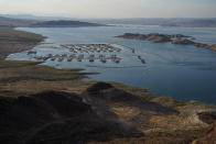 Boats fill slips at a marina on Lake Mead at the Lake Mead National Recreation Area, Thursday, Aug. 13, 2020, near Boulder City, Nev. The U.S. Bureau of Reclamation is expected to release projections that suggest the levels in Lake Powell and Lake Mead dipped slightly compared with last year. (AP Photo/John Locher)