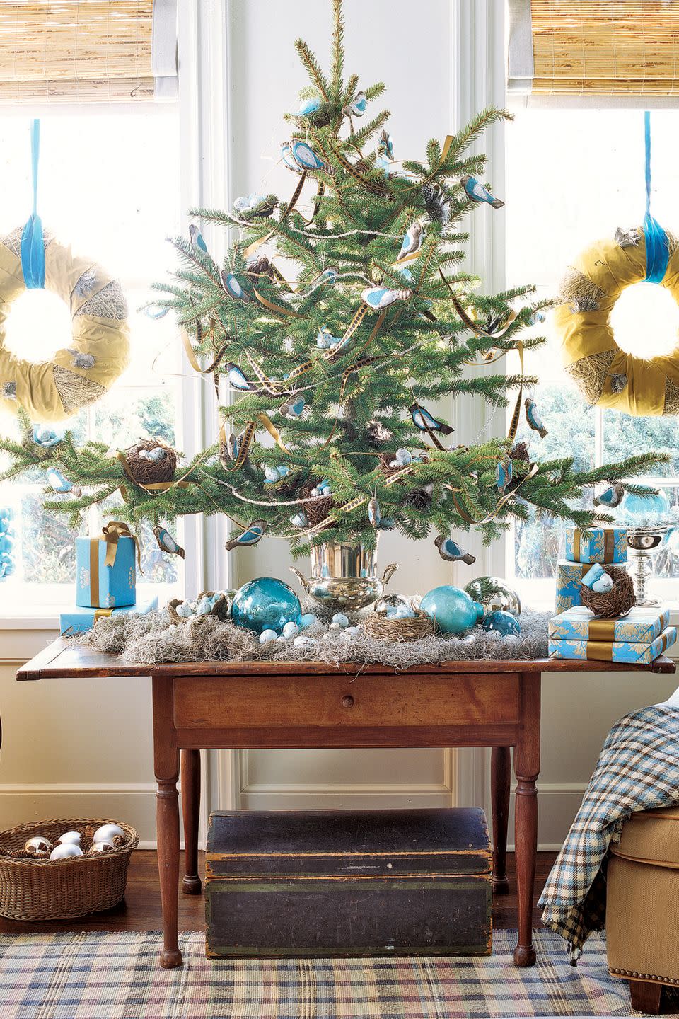 <p class="imageContent">Vivid robin's-egg blue ornaments lend this conifer top (often sold by tree farms and vendors) a touch of whimsy. Handmade taffeta birds alight in the branches, making their home among faux nests and glass- and foil-covered eggs. A champagne bucket makes a one-of-a-kind tree stand.</p><p><a class="link " href="https://www.amazon.com/Creative-Co-op-HD4474-Speckled-Ceramic/dp/B0014BUL6M/ref=sr_1_2?dchild=1&keywords=robins+egg+ornaments+blue&qid=1603208242&s=home-garden&sr=1-2&tag=syn-yahoo-20&ascsubtag=%5Bartid%7C10050.g.1251%5Bsrc%7Cyahoo-us" rel="nofollow noopener" target="_blank" data-ylk="slk:SHOP EGG ORNAMENTS;elm:context_link;itc:0;sec:content-canvas">SHOP EGG ORNAMENTS</a></p>