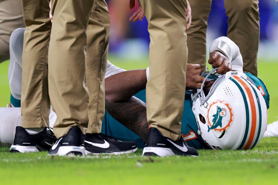 MIAMI GARDENS, FLORIDA - SEPTEMBER 12: Tua Tagovailoa #1 of the Miami Dolphins lays on the ground after colliding with Damar Hamlin #3 of the Buffalo Bills during the third quarter in the game at Hard Rock Stadium on September 12, 2024 in Miami Gardens, Florida. (Photo by Carmen Mandato/Getty Images)