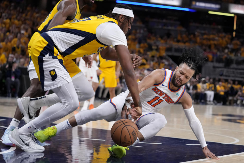 Indiana Pacers center Myles Turner, left, fights for a loose ball with New York Knicks guard Jalen Brunson (11) during the first half of Game 6 in an NBA basketball second-round playoff series, Friday, May 17, 2024, in Indianapolis. (AP Photo/Michael Conroy)