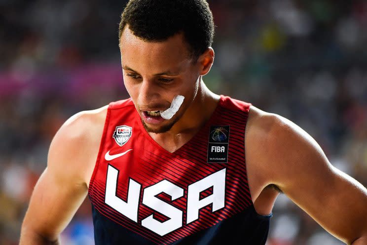 Stephen Curry chews his mouthguard at the 2014 FIBA World Cup. (Getty Images)