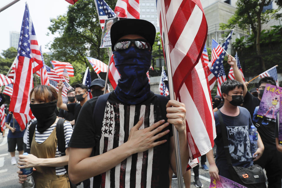 Protesters shout slogans during a protest in Hong Kong, Sunday, Sept. 8, 2019. Demonstrators in Hong Kong plan to march to the U.S. Consulate on Sunday to drum up international support for their protest movement, a day after attempts to disrupt transportation to the airport were thwarted by police. (AP Photo/Kin Cheung)