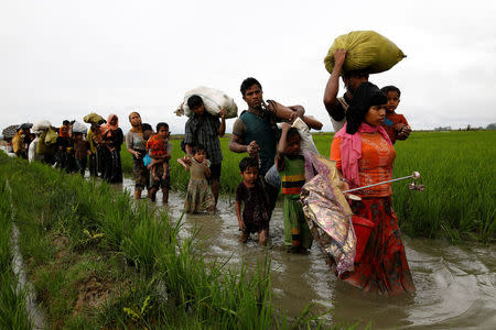 A group of Rohingya refugee people walk in the water after crossing the Bangladesh-Myanmar border in Teknaf, Bangladesh, September 1, 2017. REUTERS/Mohammad Ponir Hossain