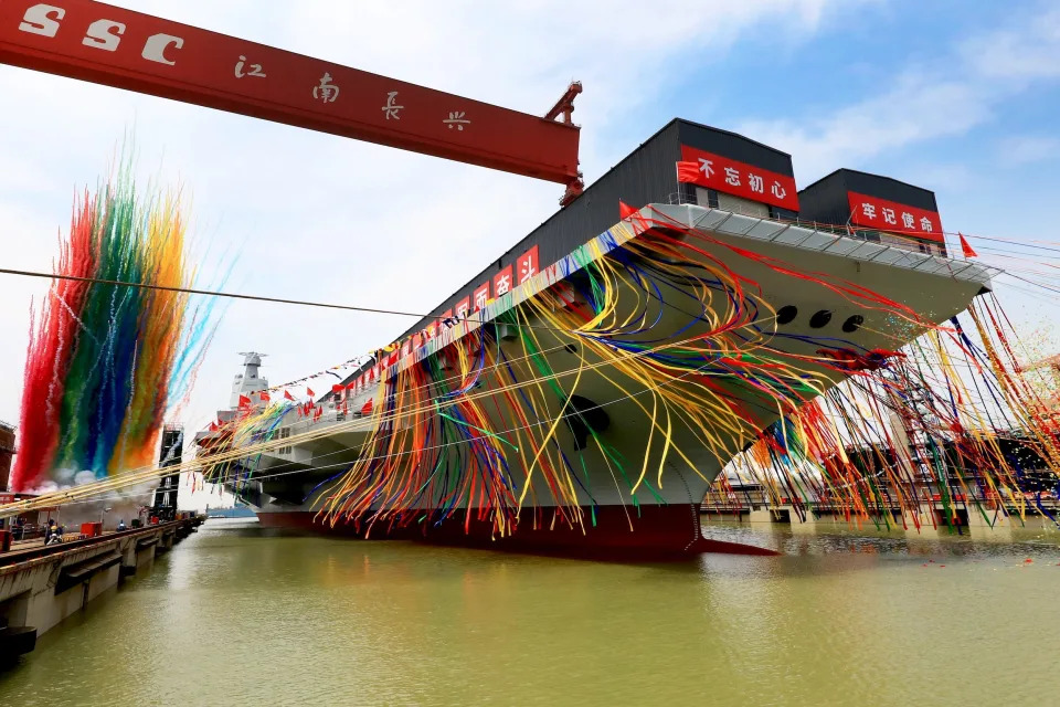 China's third aircraft carrier, the Fujian, adorns colorful decorations during a launching ceremony at Jiangnan Shipyard.