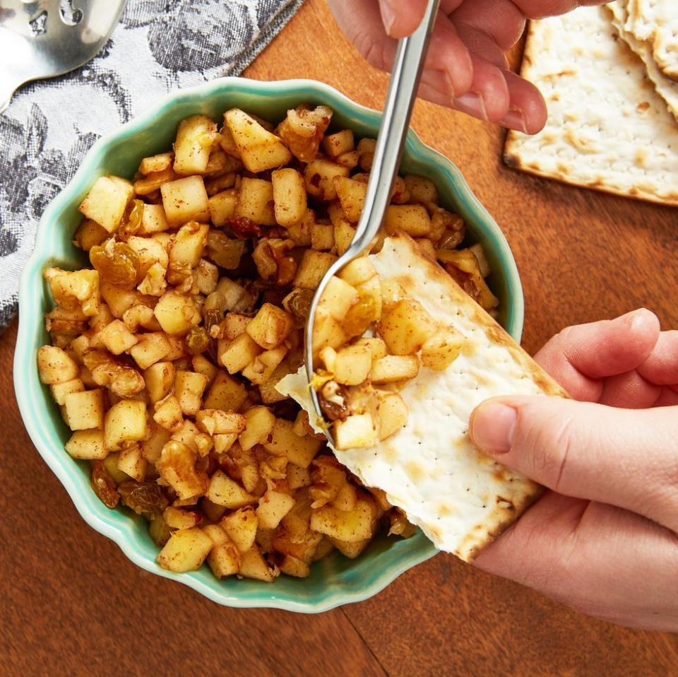 a closeup of classic charoset in a green bowl