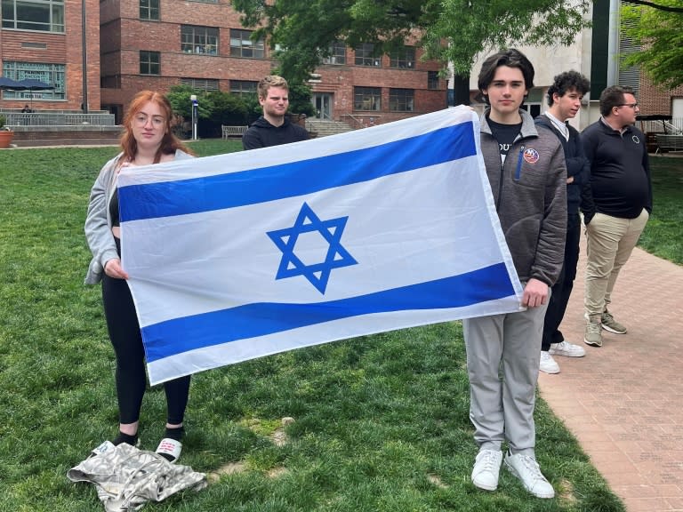 Philosophy student Skyler Sieradzky, 21, left, holds an Israeli flag as pro-Palestinian protesters stage a sit-in on the urban campus of George Washington University in Washington (SAUL LOEB)