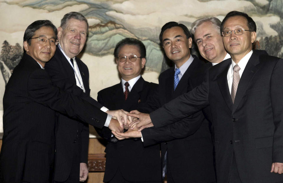 Heads of various delegations join hands before their talks in Beijing, China on Aug. 27, 2003. The U.S. was brought back to the negotiating table with North Korea in 2003, this time under the framework of six-party talks that also involved South Korea, China, Russia and Japan.