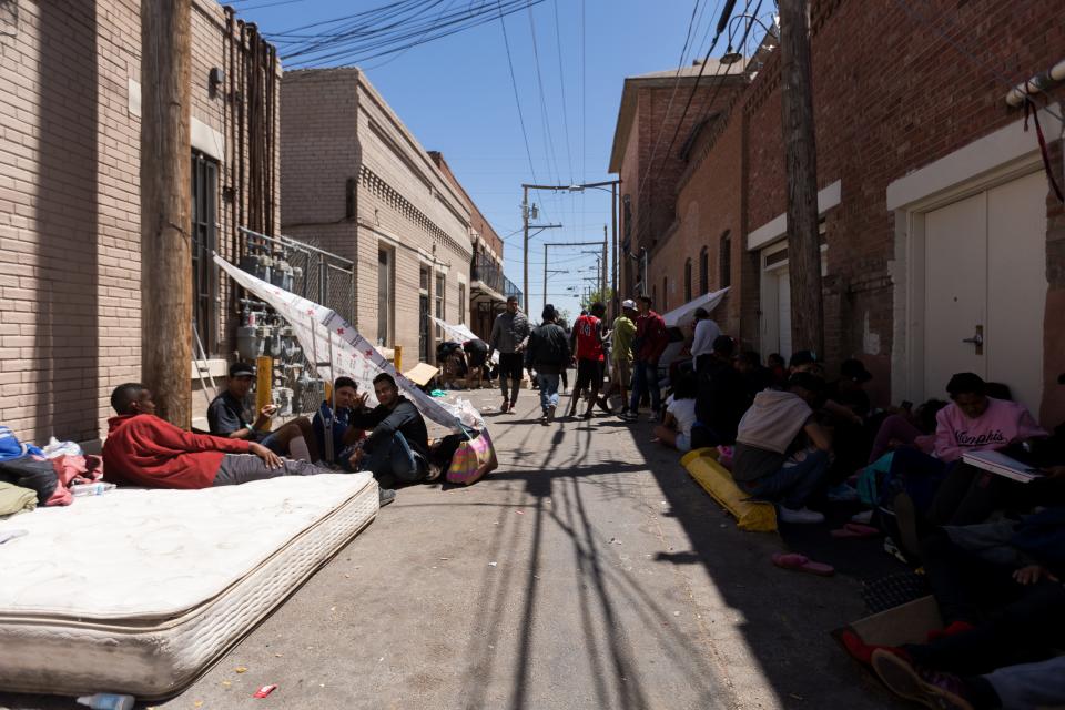 Migrants stay in front and across the street of Sacred Heart Church in Downtown El Paso on Saturday, April 29, 2023, after crossing to the U.S.