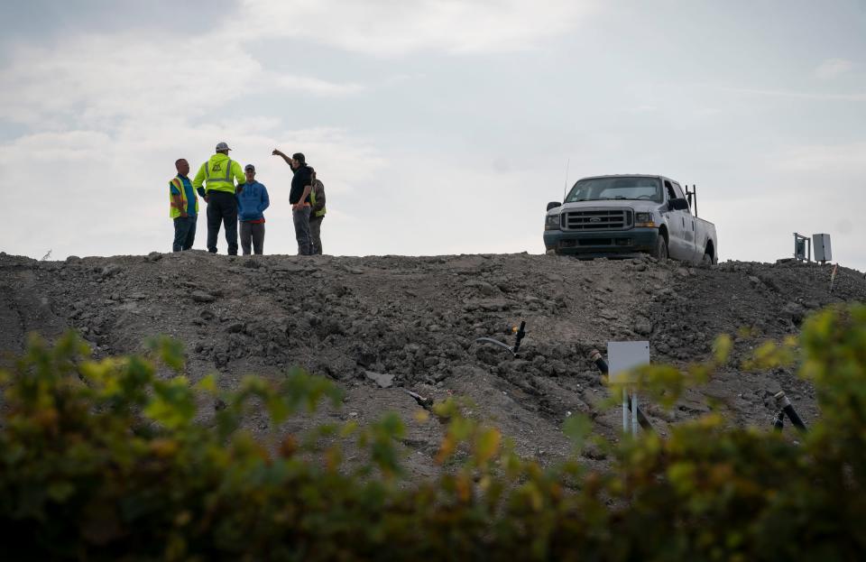 Workers gather on a ridge at a disposal landfill, Wayne Disposal Inc. in Belleville that is located near the Willow Run Airport on Wednesday, Sept. 20, 2023.