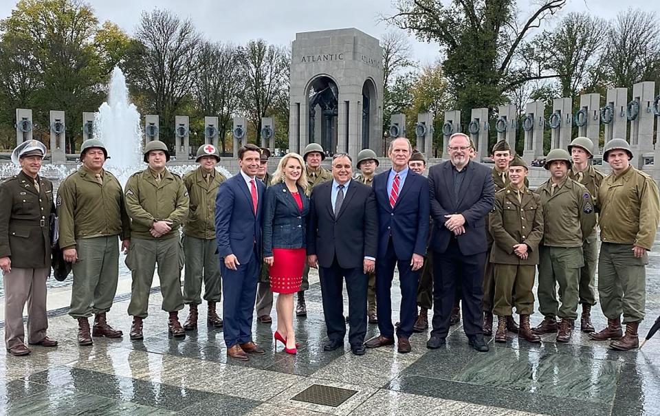 Matt and Melanie Miller pose with a group of WWII re-enactors, Crew 1944, Chris Long, president of the Ohio Christian Alliance and U.S Congressman Bill Johnson who was the featured speaker at the Veterans Day D-Day Prayer addition celebration at the World War II Memorial in Washington, D.C.