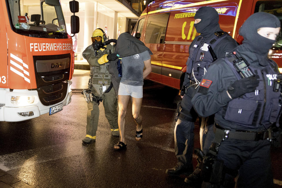 A man is taken into custody by a Special Operations Command in Castrop-Rauxel, Sunday, Jan.8, 2023. In Castrop-Rauxel, there was a large-scale operation by the police and fire department on Saturday evening. A special task force (SEK) was also on the scene, a police spokeswoman told the German Press Agency on Saturday evening. (Karsten Wickern/dpa via AP)