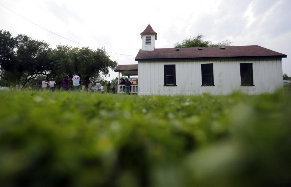 In this Wednesday May 1, 2019 photo, descendants of Nathaniel Jackson gather at the Jackson Ranch in San Juan, Texas. Nathaniel Jackson founded the ranch in 1857, and it includes two cemeteries and a chapel that, according to family lore, was the first Protestant church in South Texas' Rio Grande Valley. (AP Photo/Eric Gay)
