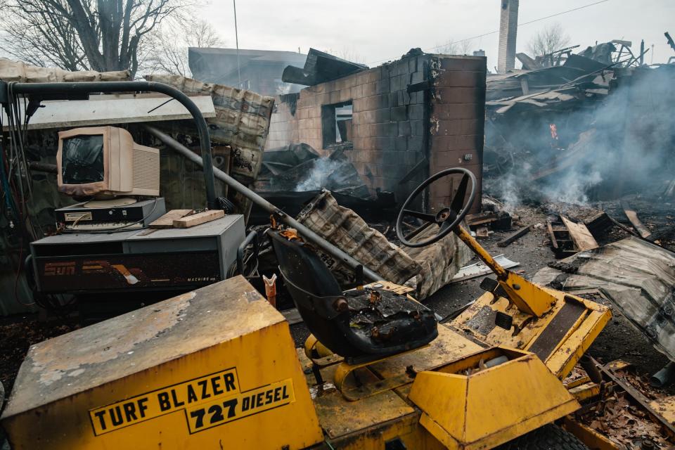 Spot fires of debris continue to smolder at Lincolns and Things on Tuesday in Sherrodsville. A fire Monday afternoon leveled the structure, which also warehoused approximately 8,000 toys for Tuscarawas County Toys for Tots.