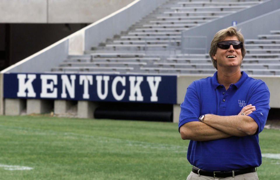 FILE - Kentucky coach Hal Mumme smiles as he waits for a photo shoot during the team's media day on Aug. 12, 1999, at Commonwealth Stadium in Lexington, Ky. Of the top 25 most-prolific passing seasons in major college football history by yards per game, 12 have direct connections to Mumme and Mike Leach — from Kentucky to Houston to Texas Tech to New Mexico State to Washington State. (AP Photo/Ed Reinke, File)