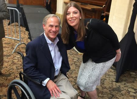 Architect Ashley Smith, 45, a transgender woman, is pictured with Texas Governor Greg Abbott (seated) in San Antonio, Texas, U.S., on July 14, 2017. Picture taken on July 14, 2017. Courtesy Ashley Smith/Handout via REUTERS