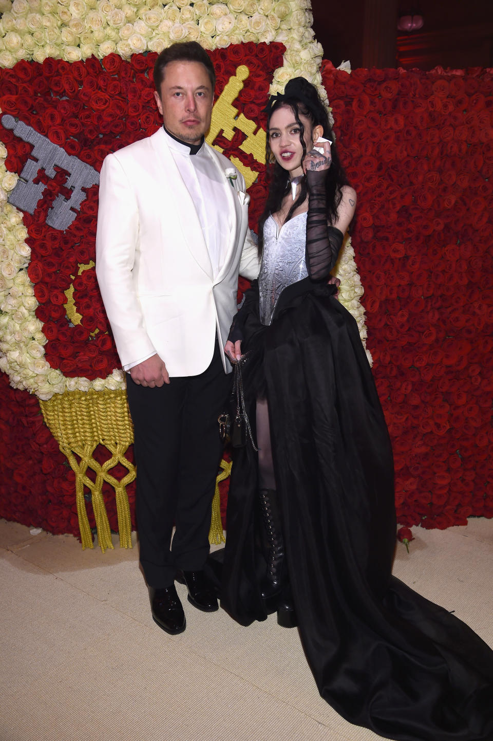 NEW YORK, NY - MAY 07:  Elon Musk and Grimes attend the Heavenly Bodies: Fashion & The Catholic Imagination Costume Institute Gala at The Metropolitan Museum of Art on May 7, 2018 in New York City.  (Photo by Dimitrios Kambouris/MG18/Getty Images for The Met Museum/Vogue)