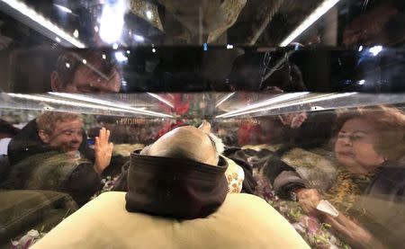 Faithful surround the exhumed body of the mystic saint Padre Pio in the Catholic church of San Lorenzo fuori le Mura in Rome, February 3, 2016. REUTERS/Yara Nardi