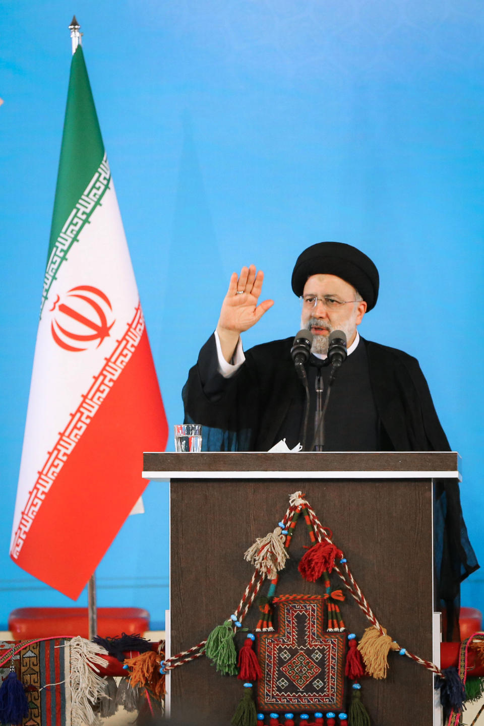 In this photo released by the official website of the office of the Iranian Presidency, President Ebrahim Raisi waves to a crowd during a visit to central city of Shar-e Kord, Iran, Thursday, June 9, 2022. A day after the International Atomic Energy Agency's board of governors censured Tehran for failing to provide "credible information" over man-made nuclear material found at three undeclared sites in the country, President Raisi took a firm stance saying Iran will not withdraw from its position. (Iranian Presidency Office via AP)