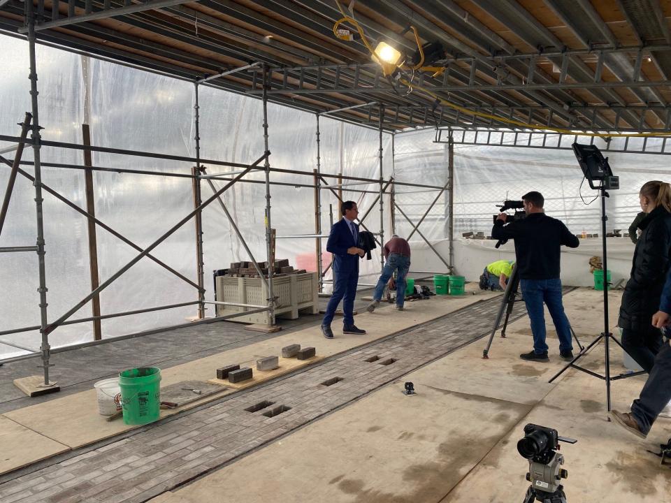 Doug Boles tapes a future episode of 'Beyond The Bricks' as grounds crew folks finish the historic renovations of the Yard of Bricks that took place over the winter.