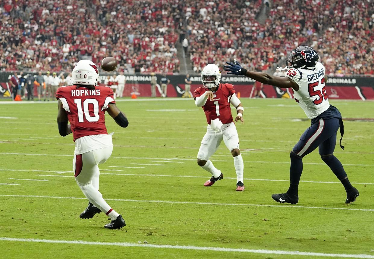 Oct 24, 2021; Glendale, Arizona, USA; Arizona Cardinals quarterback Kyler Murray (1) throws a touchdown pass to wide receiver DeAndre Hopkins (10) against Houston Texans defensive end Jonathan Greenard (52) in the first half at State Farm Stadium.