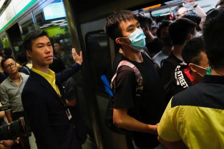 Anti-extradition bill demonstrators block a Mass Transit Railway (MTR) train in Hong Kong