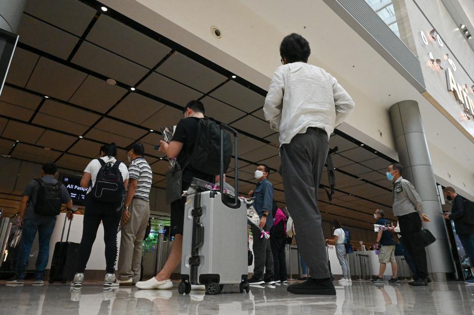 Passengers line up at the immigration checkpoint at Singapore's Changi Airport.