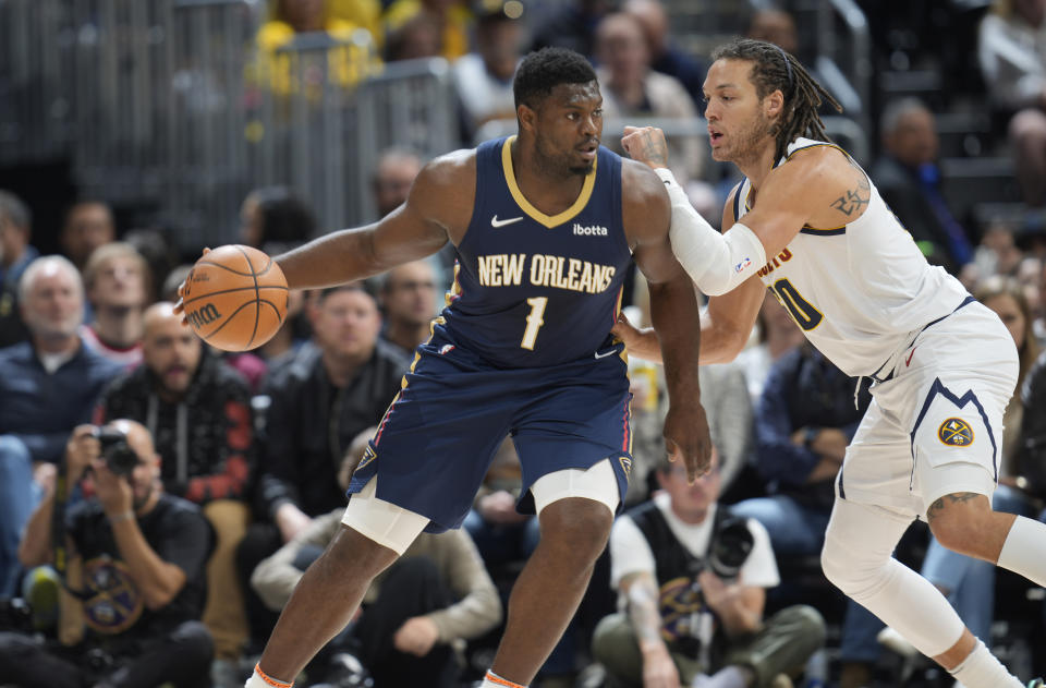 New Orleans Pelicans forward Zion Williamson, left, looks to drive to the basket as Denver Nuggets forward Aaron Gordon, right, defends in the first half of an NBA basketball game Monday, Nov. 6, 2023, in Denver. (AP Photo/David Zalubowski)