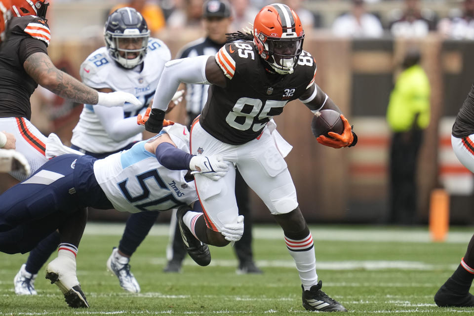 Cleveland Browns tight end David Njoku (85) is tackled by Tennessee Titans linebacker Jack Gibbens, left, after a catch during the first half of an NFL football game Sunday, Sept. 24, 2023, in Cleveland. (AP Photo/Sue Ogrocki)