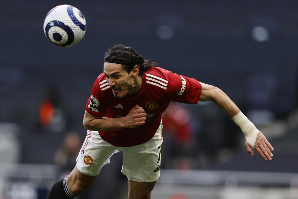 Manchester United's Edinson Cavani in action during the English Premier League soccer match between Tottenham Hotspur and Manchester United at the Tottenham Hotspur Stadium in London, Sunday, April 11, 2021. (Adrian Dennis/Pool via AP)