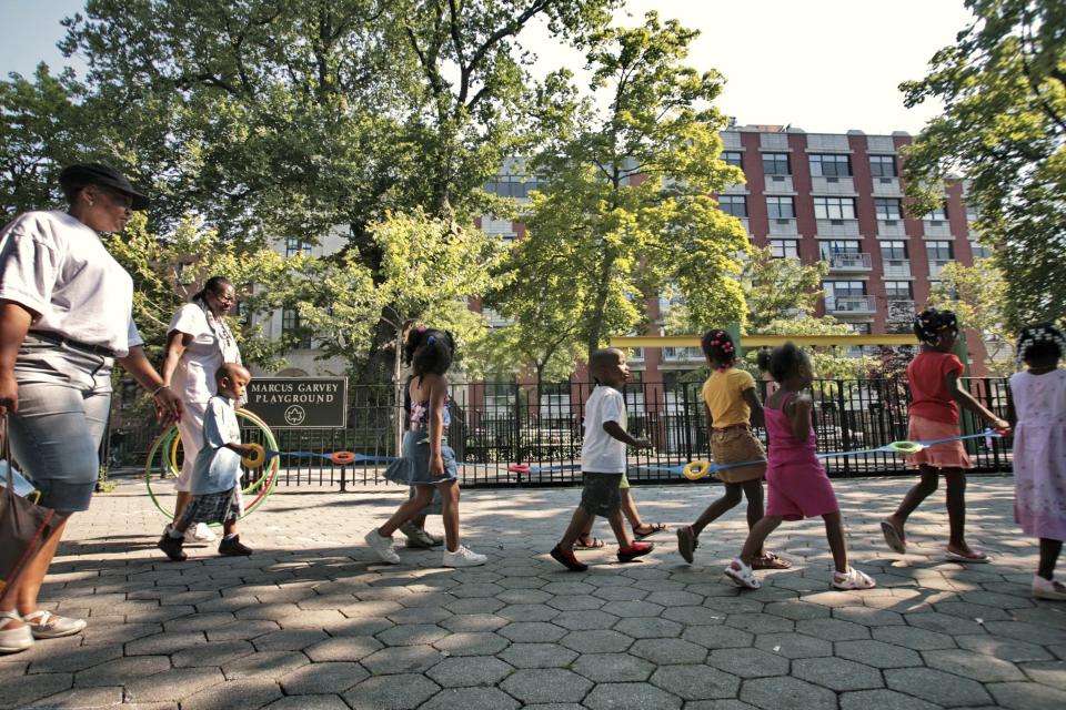 Children from a nearby daycare are escorted in Marcus Garvey Park in the Harlem neighborhood of New York. (Credit: Bebeto Matthews, AP Photo)