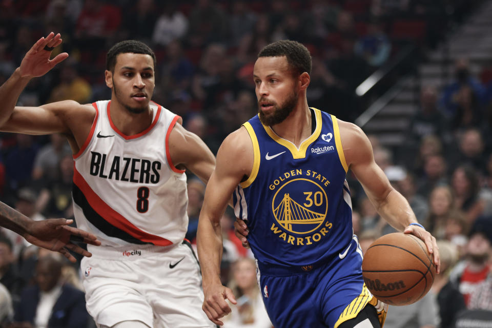 PORTLAND, OREGON - APRIL 11: Stephen Curry #30 of the Golden State Warriors drives against Kris Murray #8 of the Portland Trail Blazers during the first quarter at Moda Center on April 11, 2024 in Portland, Oregon. NOTE TO USER: User expressly acknowledges and agrees that, by downloading and or using this photograph, User is consenting to the terms and conditions of the Getty Images License Agreement.  (Photo by Amanda Loman/Getty Images)